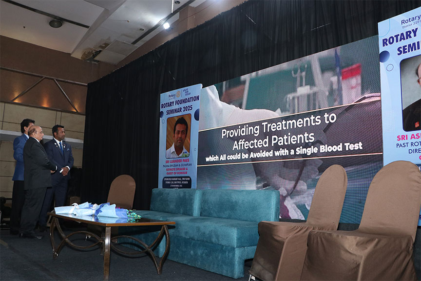 Premium conference setup with rows of chairs and branded podium, Kochi